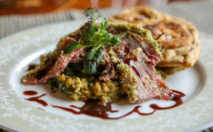 Herb Crusted Smoked Leg of Lamb with Red Wine Rosemary Reduction, Red Lentil & Spinach Dal, and fresh Naan Bread